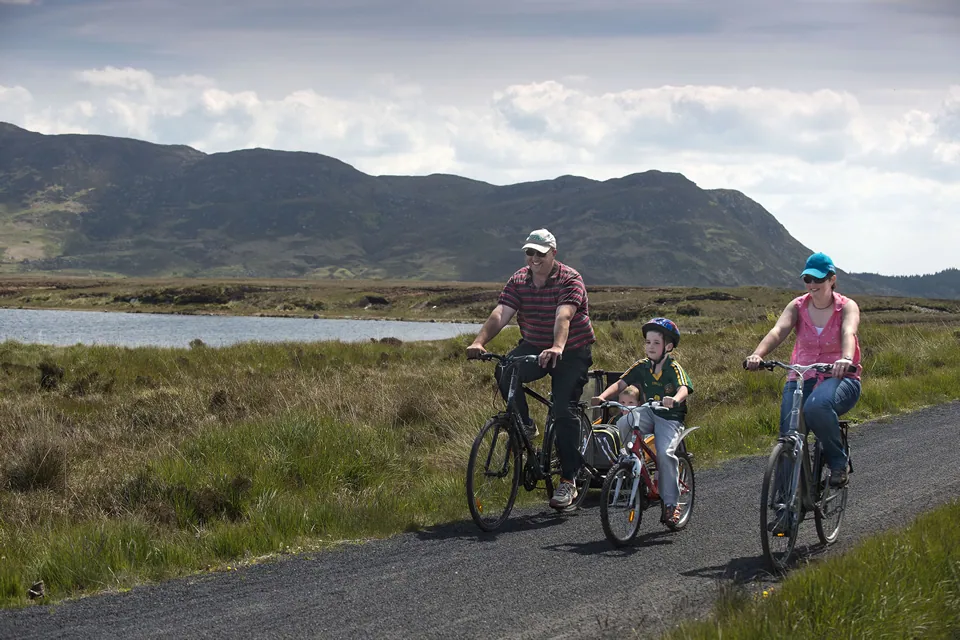 Family cycling on the Great Western Greenway at Tonragee, Achill